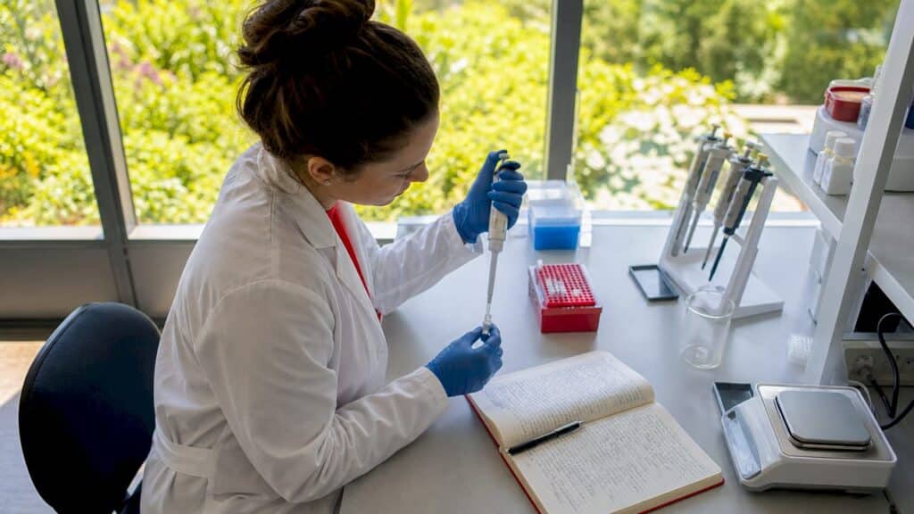 Lab technician preparing sample with pipette