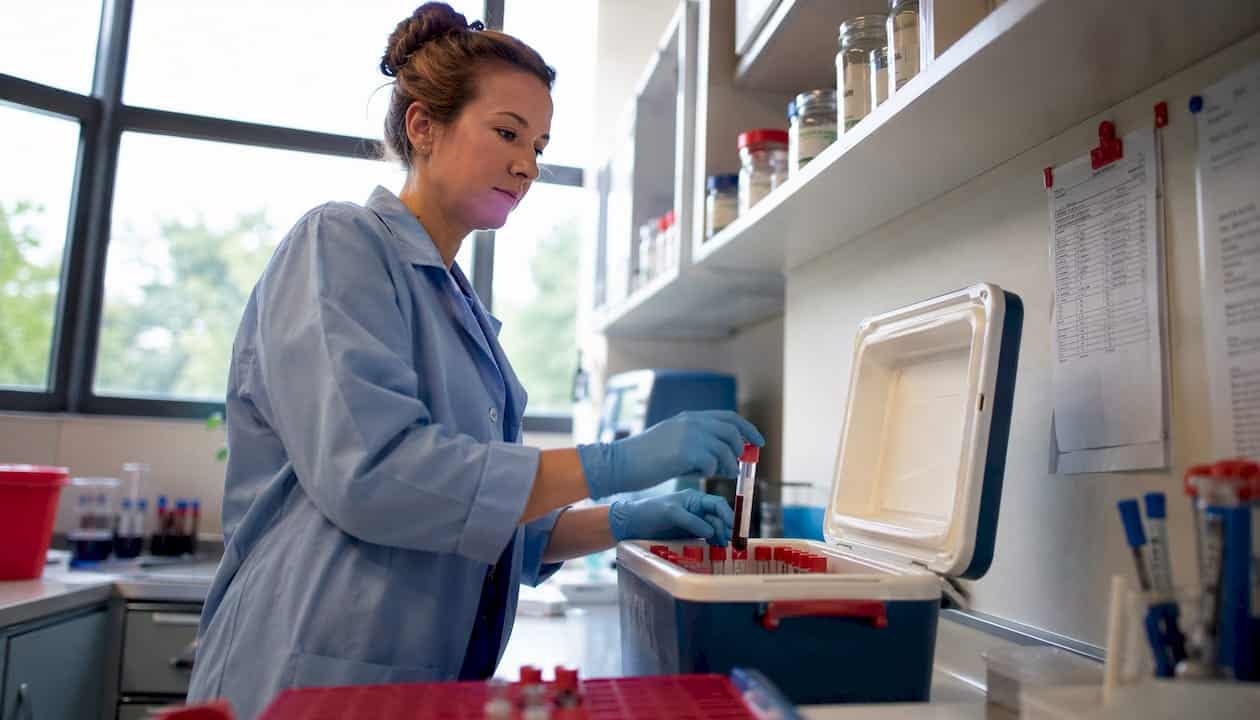 Lab technician organizing specimen tubes