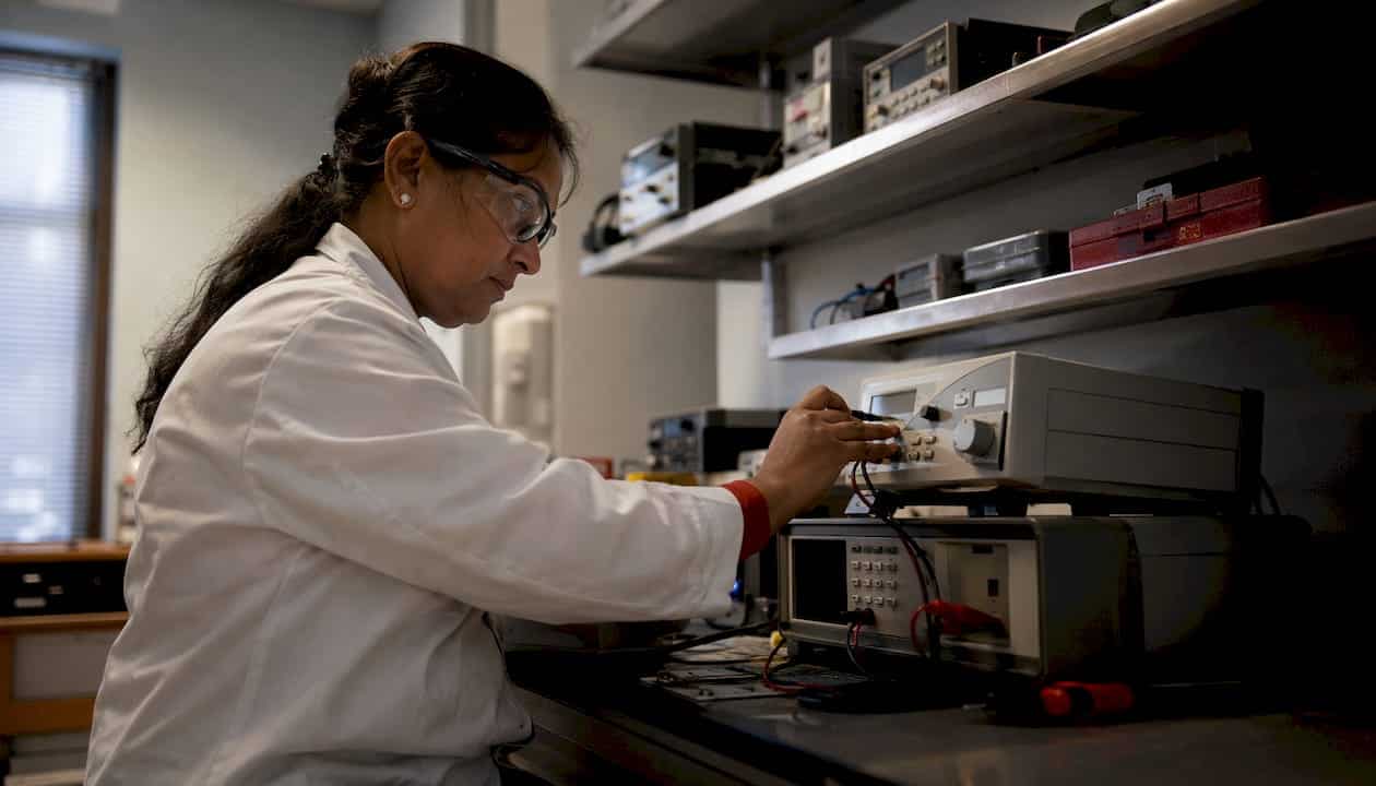 Lab manager calibrating test equipment in lab