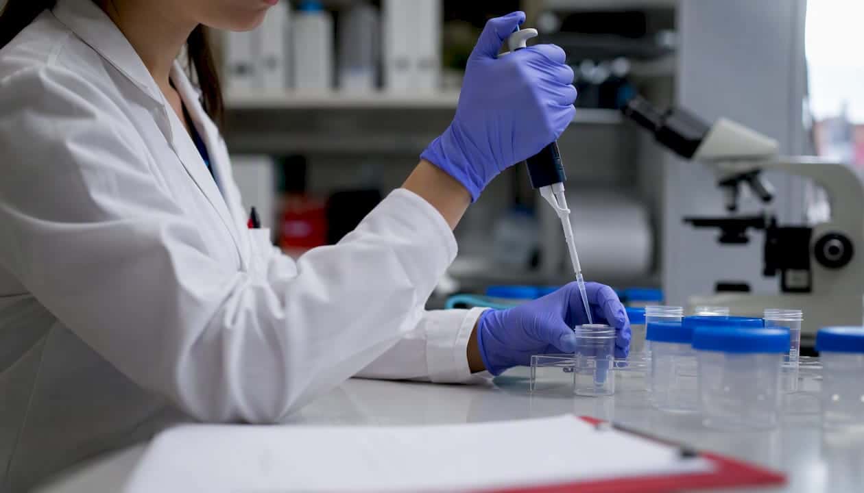 Hands of trainee performing specimen prep in lab