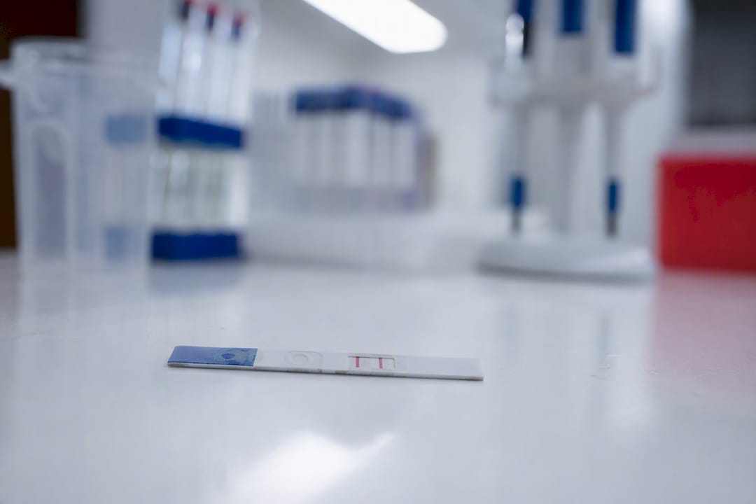 Close-up urine drug test strip with faint result lines