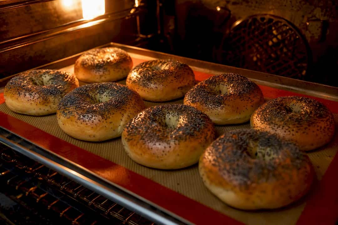Poppy seed bagels baking inside oven